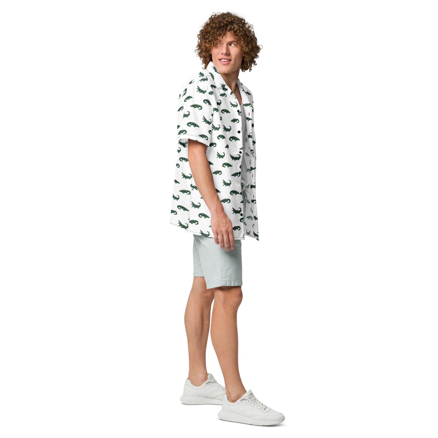 Man wearing white button-down shirt with pattern of green alligators.
