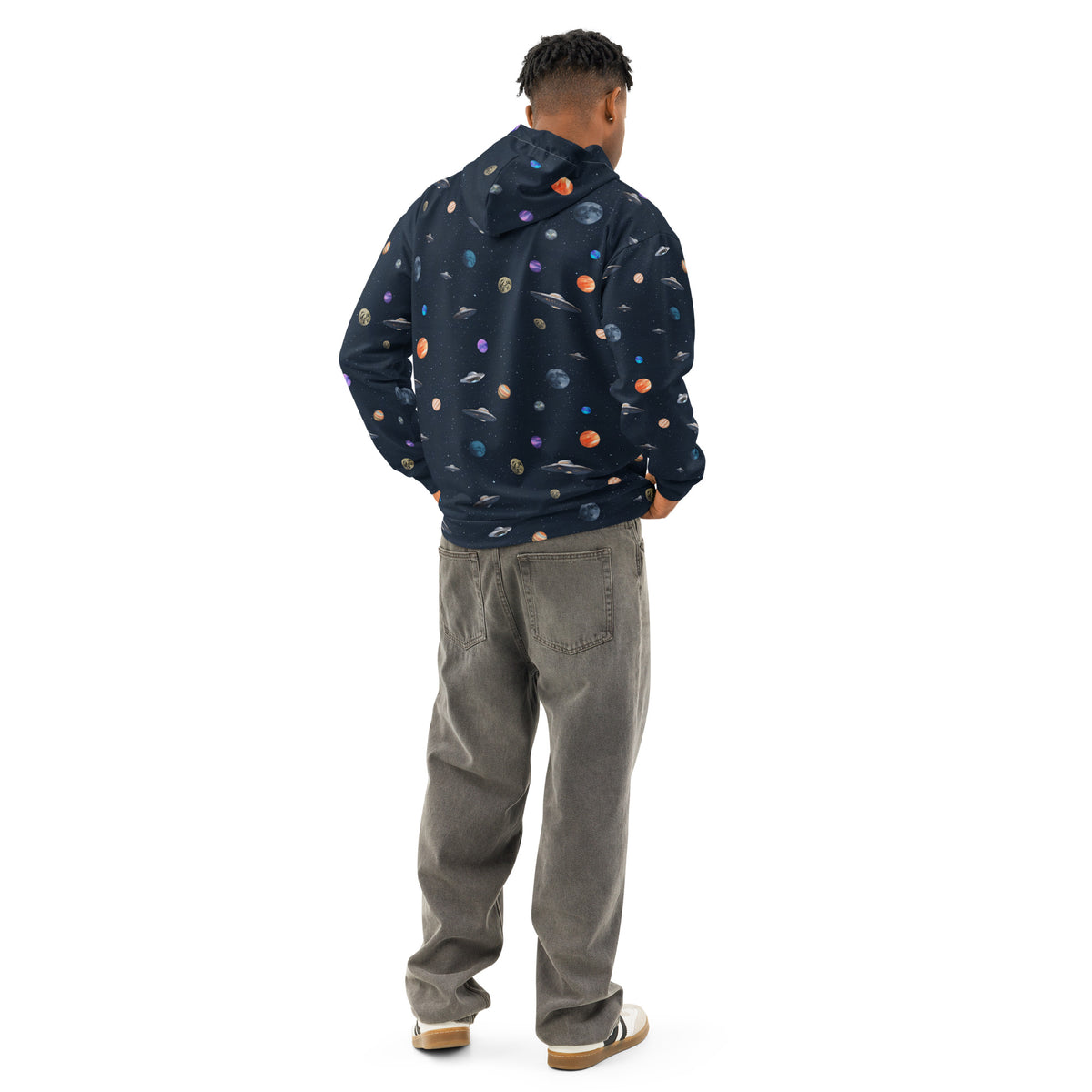 Rear view of man wearing hoodie with pattern of UFOs and planets in space.