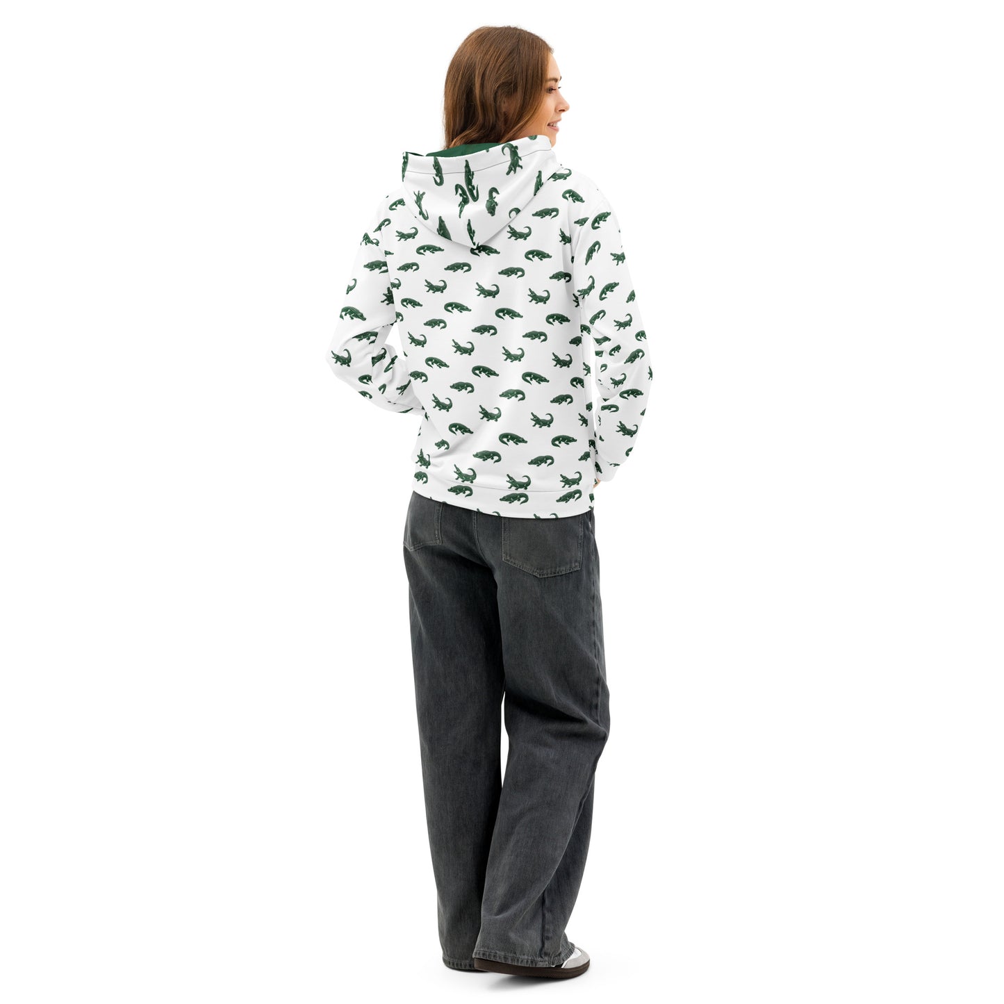 Woman wearing white sweatshirt with pattern of green alligators.