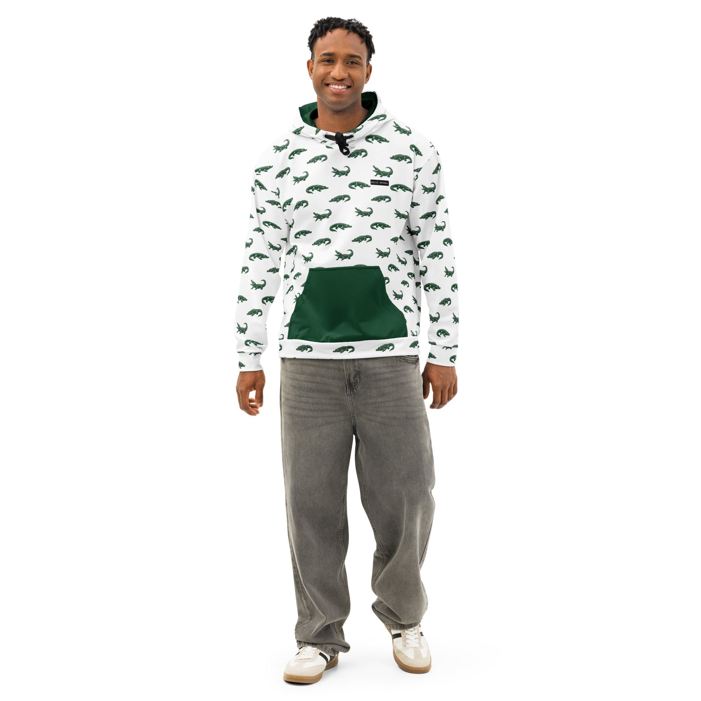 Man wearing white sweatshirt with pattern of green alligators. Hood interior and pocket are green, drawstrings are black.