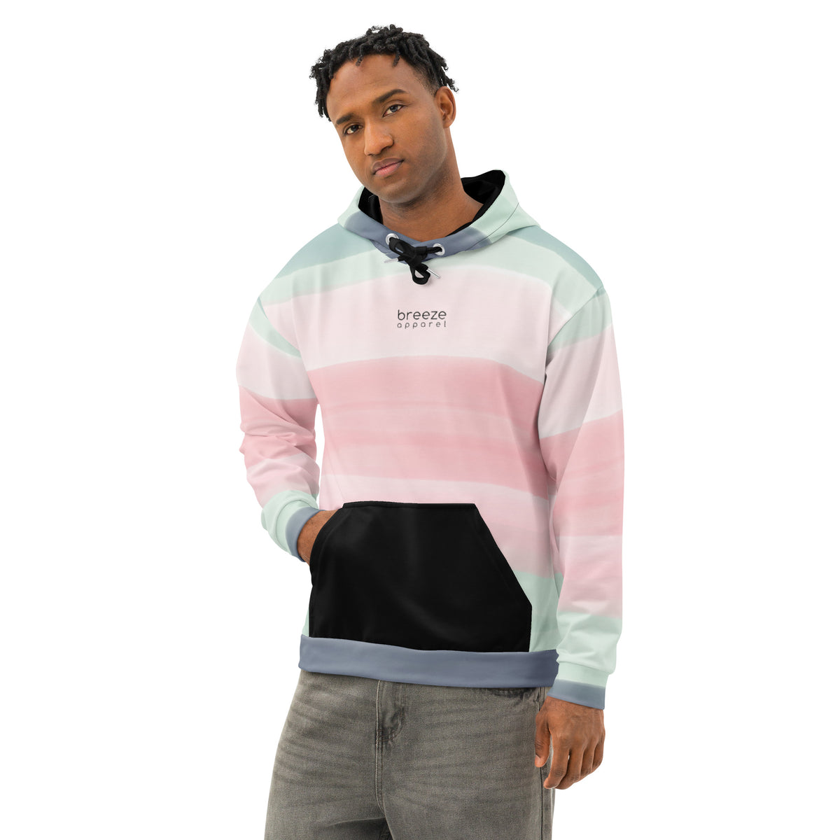 Man wearing hoodie with colors light pastel green, shades of pink, and gray in stripes, a black pocket, and 'breeze apparel' written in small text on chest.