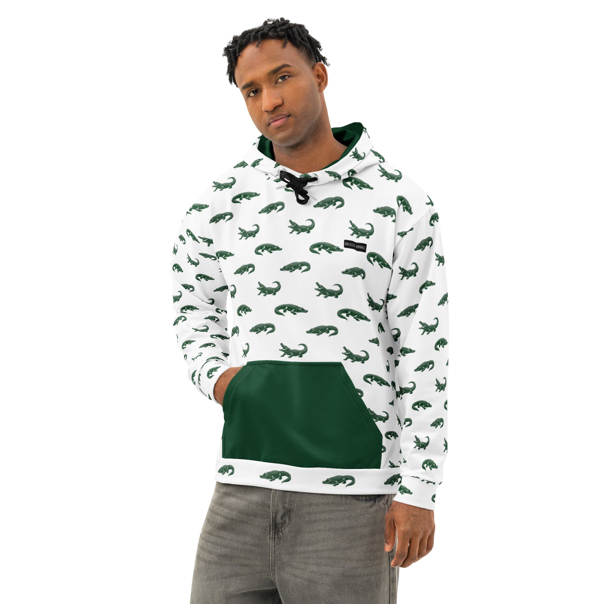 Man wearing white sweatshirt with pattern of green alligators. Hood interior and pocket are green, drawstrings are black.