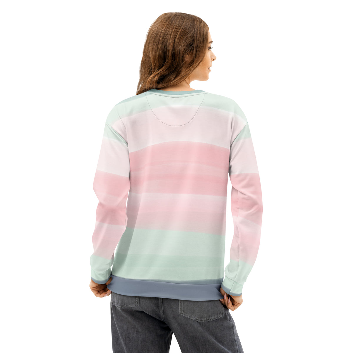 Rear view of woman wearing sweatshirt with colors light pastel green, shades of pink, and gray in stripes.