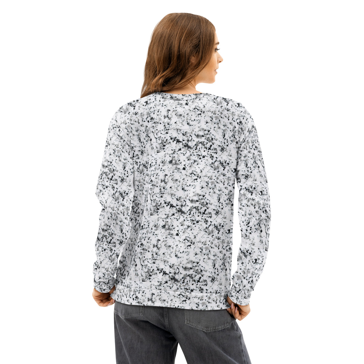 Rear view of a woman wearing a white sweatshirt with black splotches, resembling a marble countertop. Across the chest is a black rectangle with 'breeze apparel' written in white.
