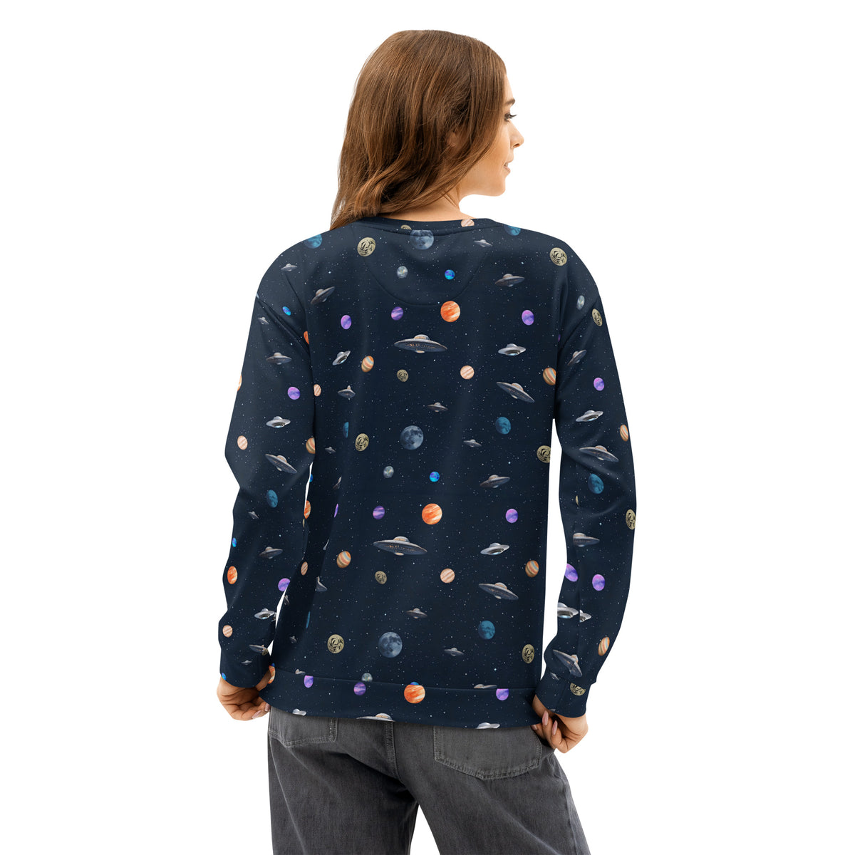 Rear view of woman wearing sweatshirt with pattern of UFOs and planets in space.