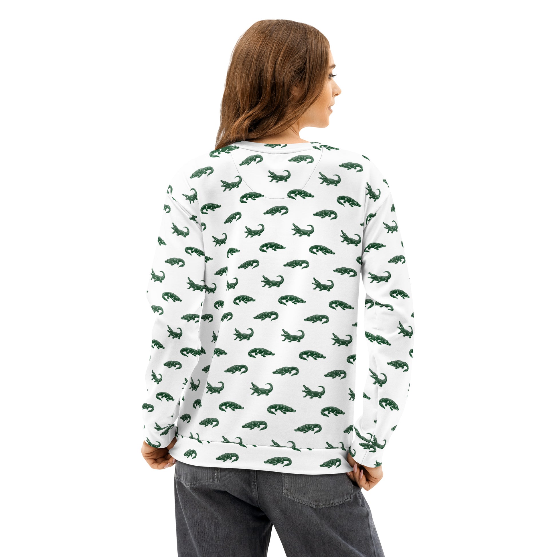 Woman wearing white sweatshirt with pattern of green alligators.