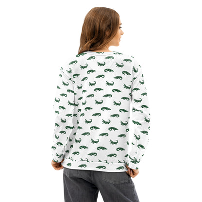 Woman wearing white sweatshirt with pattern of green alligators.