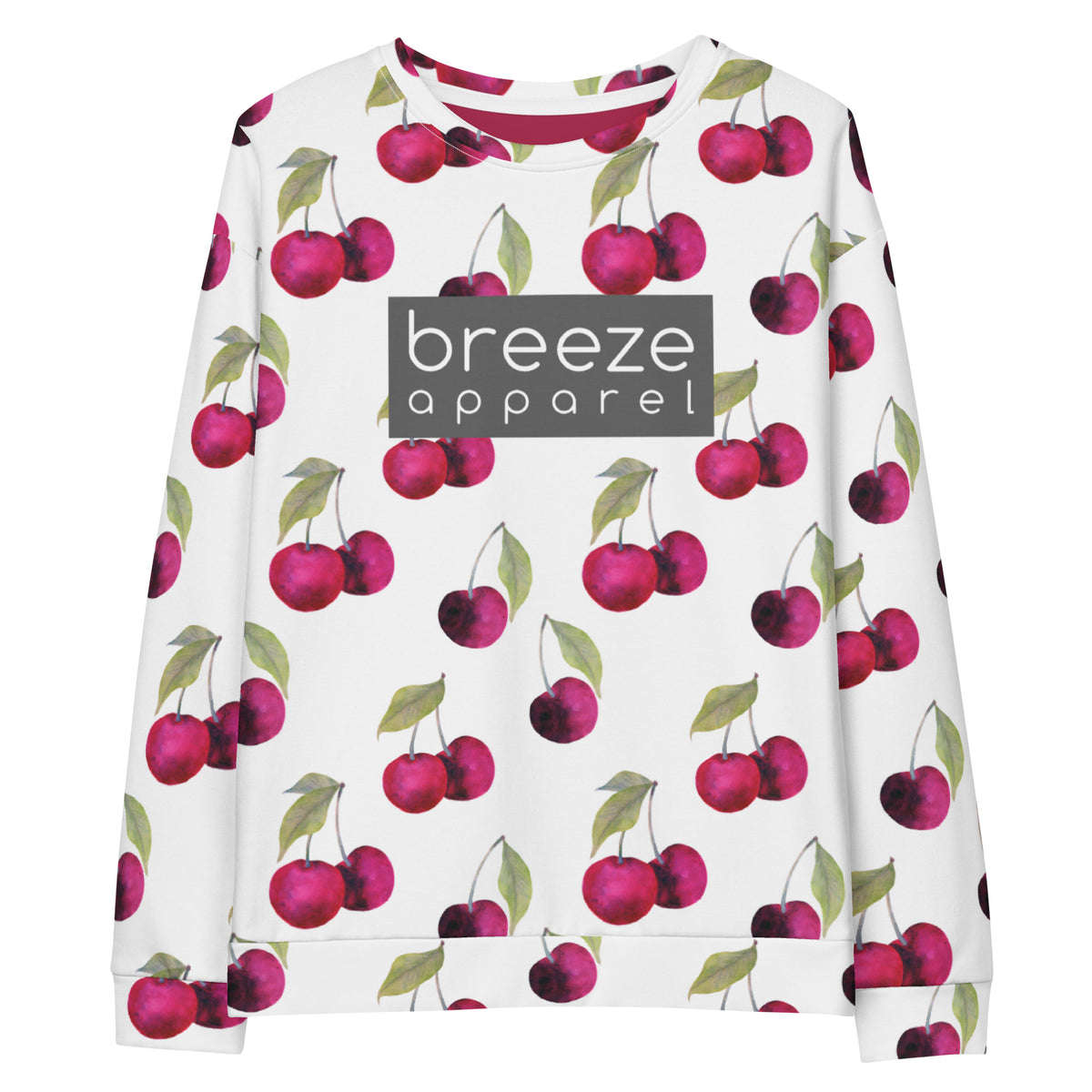 White sweatshirt with an all-over cherries design. Across the chest is a gray rectangle with 'breeze apparel' in white inside.