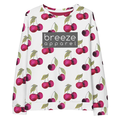 White sweatshirt with an all-over cherries design. Across the chest is a gray rectangle with 'breeze apparel' in white inside.