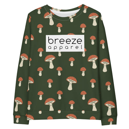 Forest-green sweatshirt with all-over mushroom pattern. A white rectangle with 'breeze apparel' written in black inside is across the chest.