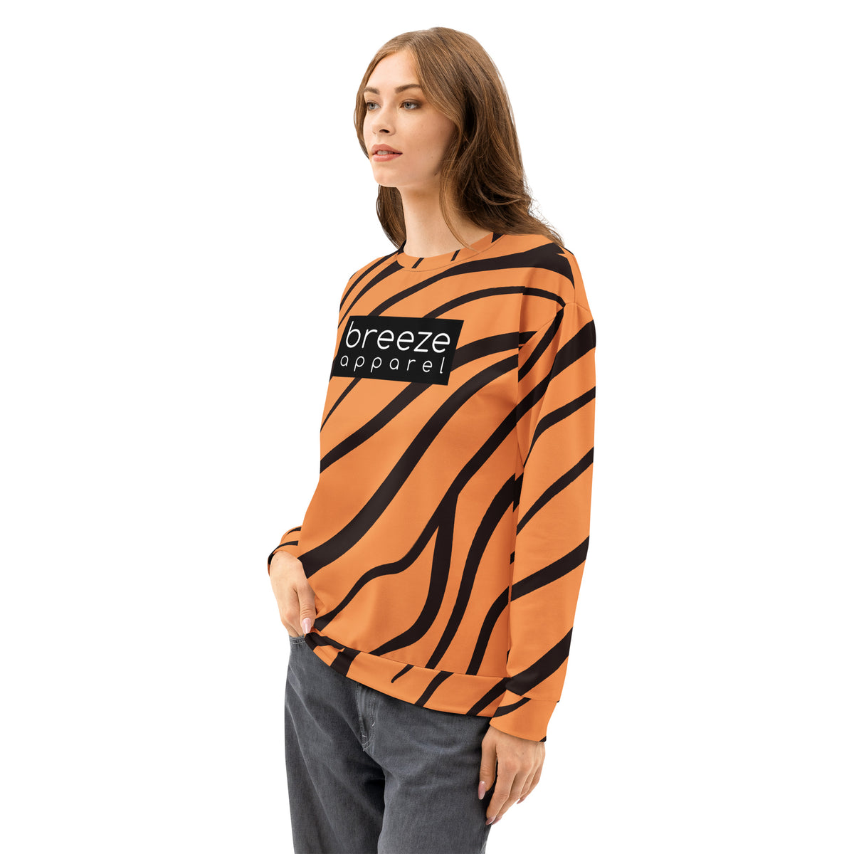 Woman wearing a sweatshirt with a tiger-fur design and a 'breeze apparel' logo consisting of white wording set in a black rectangle across the chest.