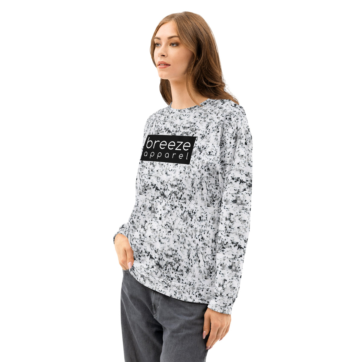 Woman wearing a white sweatshirt with black splotches, resembling a marble countertop. Across the chest is a black rectangle with 'breeze apparel' written in white.