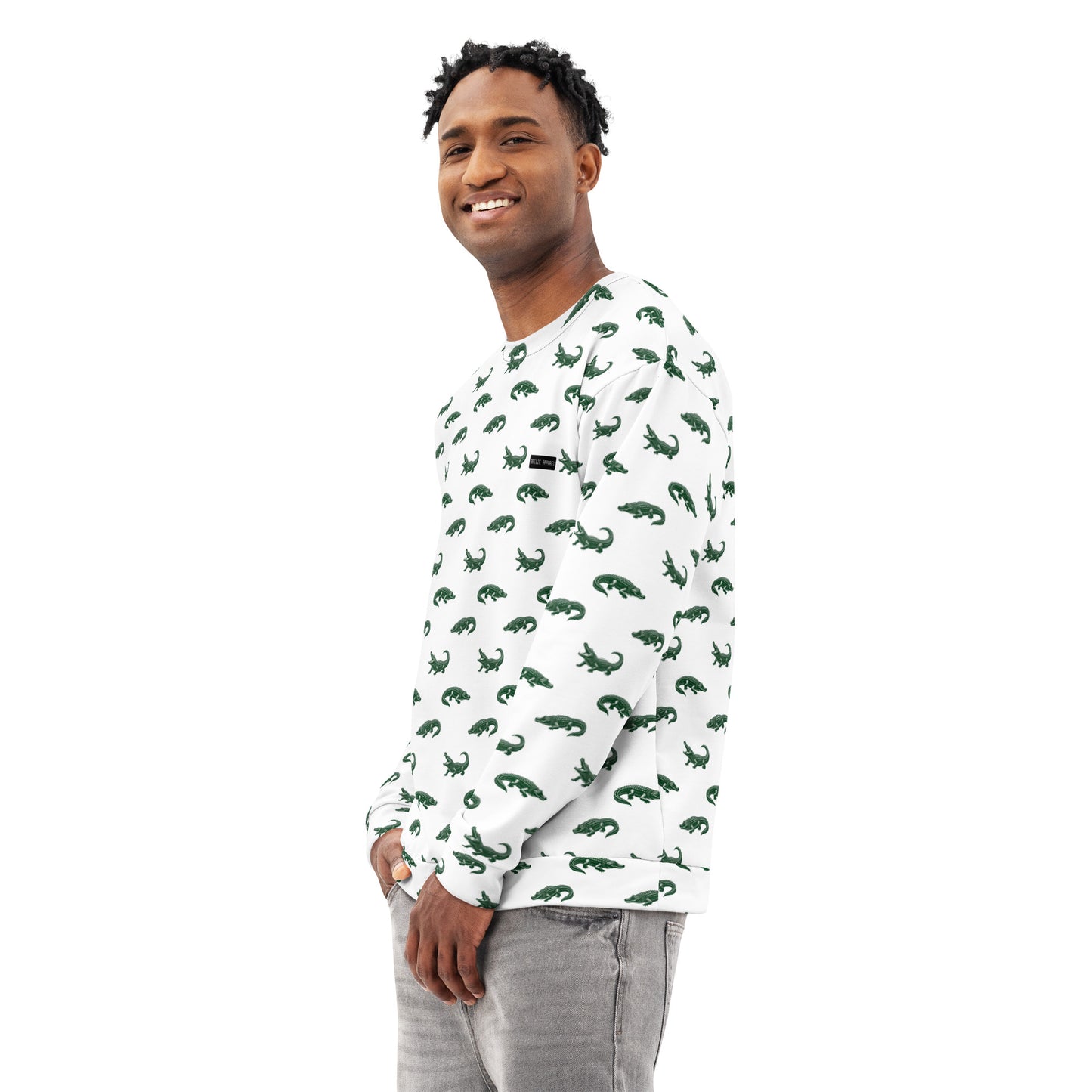 Man wearing white sweatshirt with pattern of green alligators.