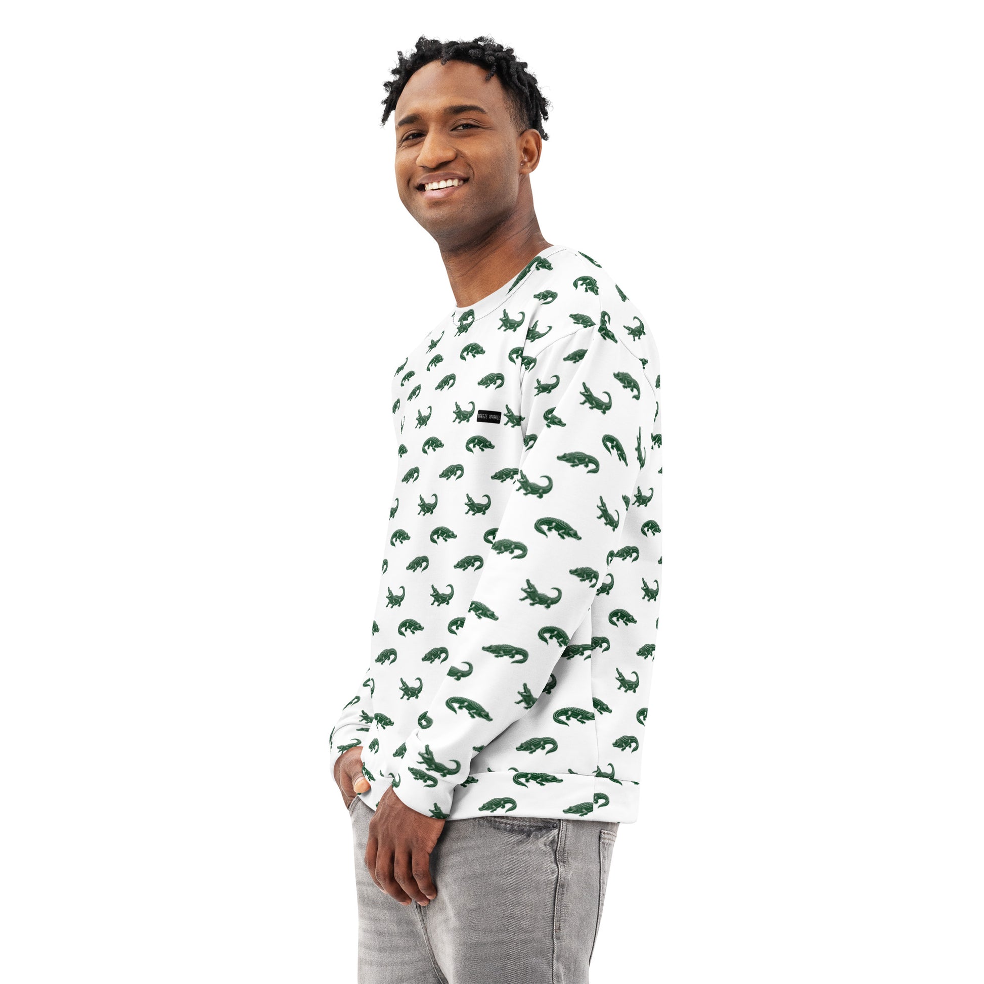 Man wearing white sweatshirt with pattern of green alligators.