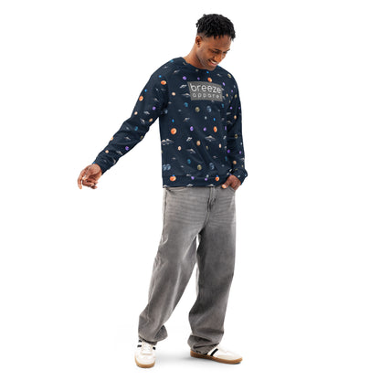 Man wearing sweatshirt with pattern of UFOs and planets in space. Chest is overlaid with gray, rectangular logo with white lettering.