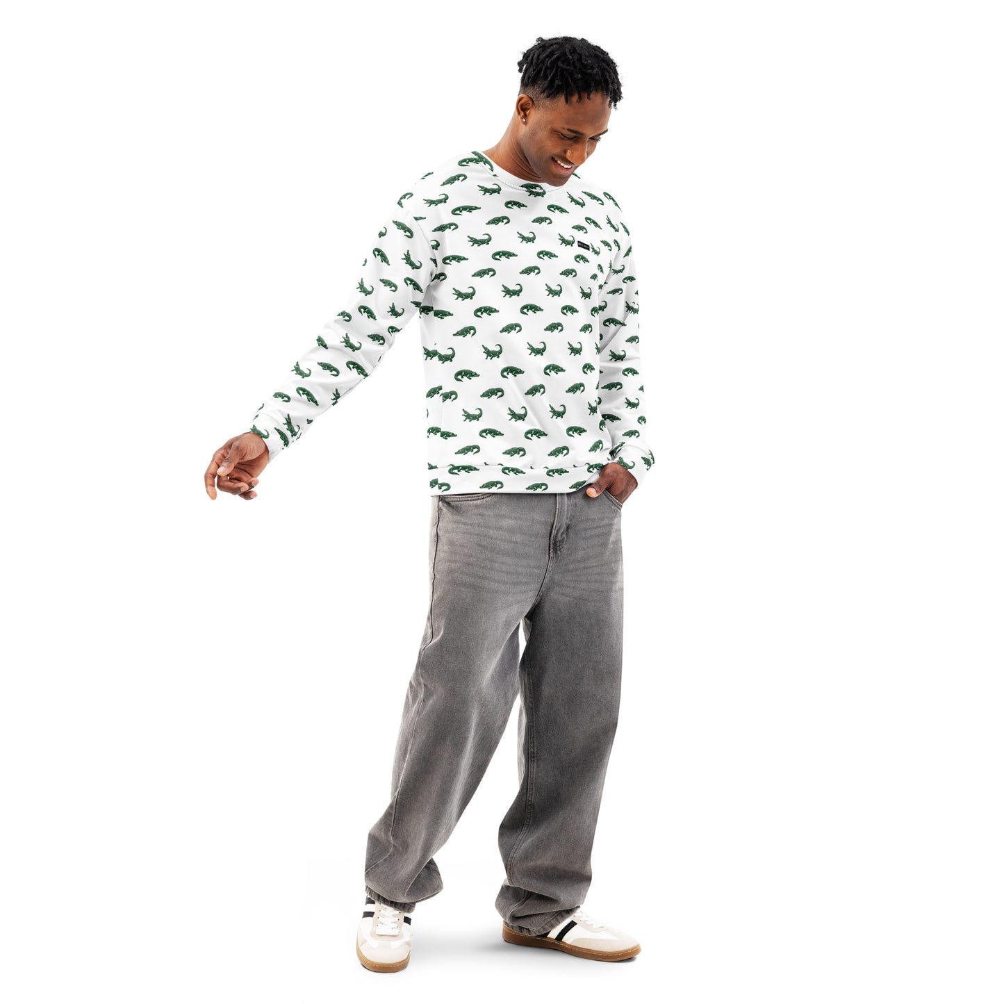 Man wearing white sweatshirt with pattern of green alligators.
