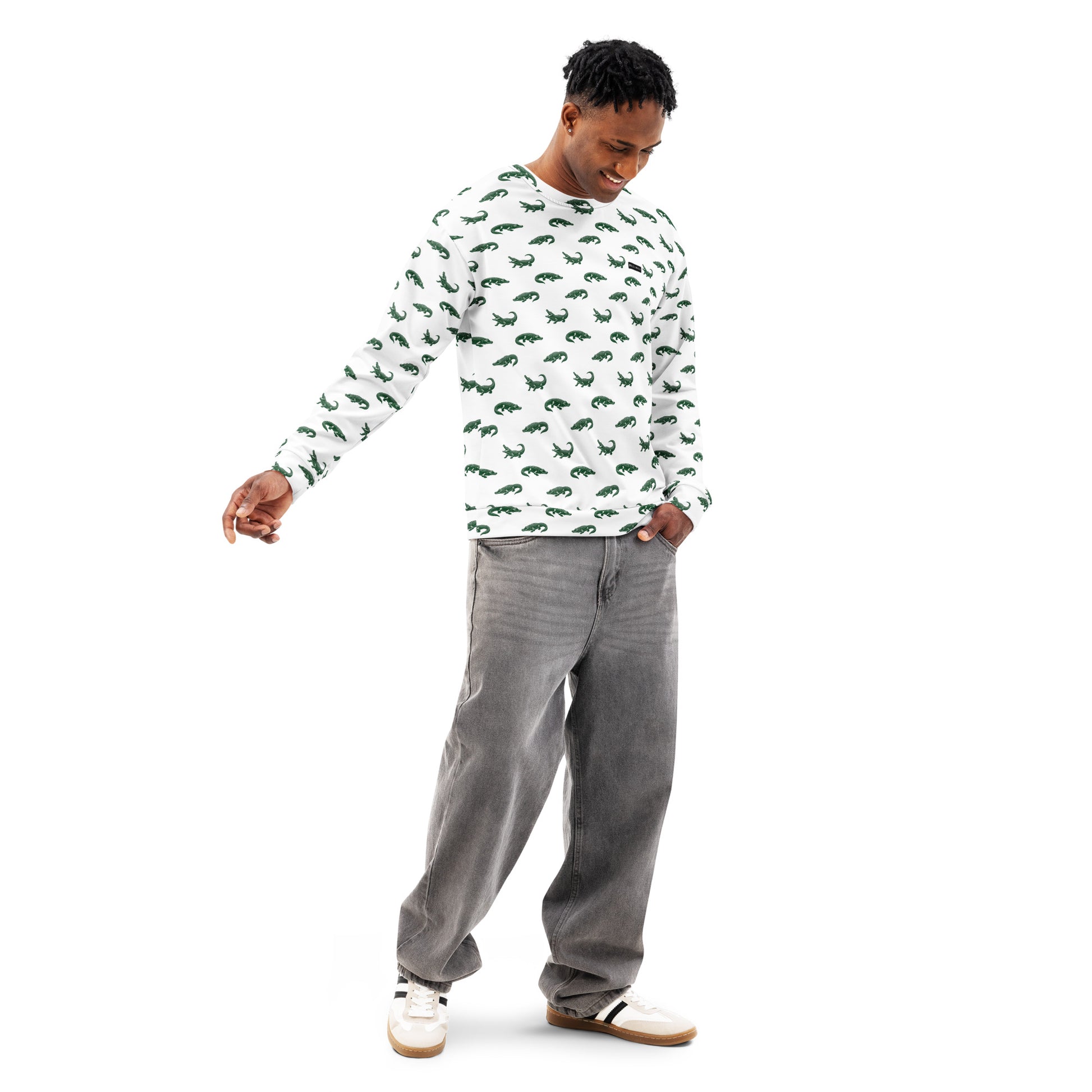 Man wearing white sweatshirt with pattern of green alligators.