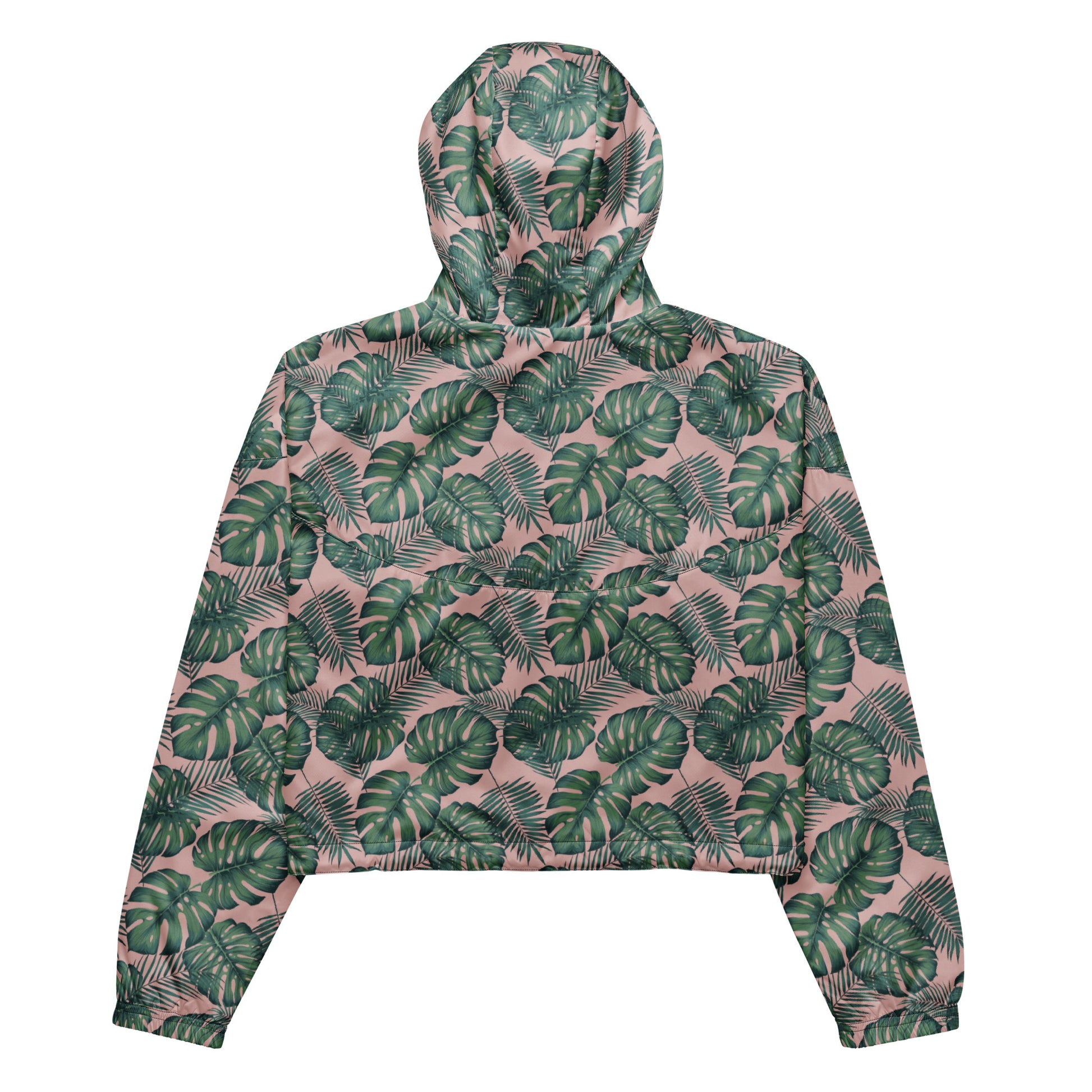 Back of cropped jacket with pattern of green palm leaves set on a pink background.
