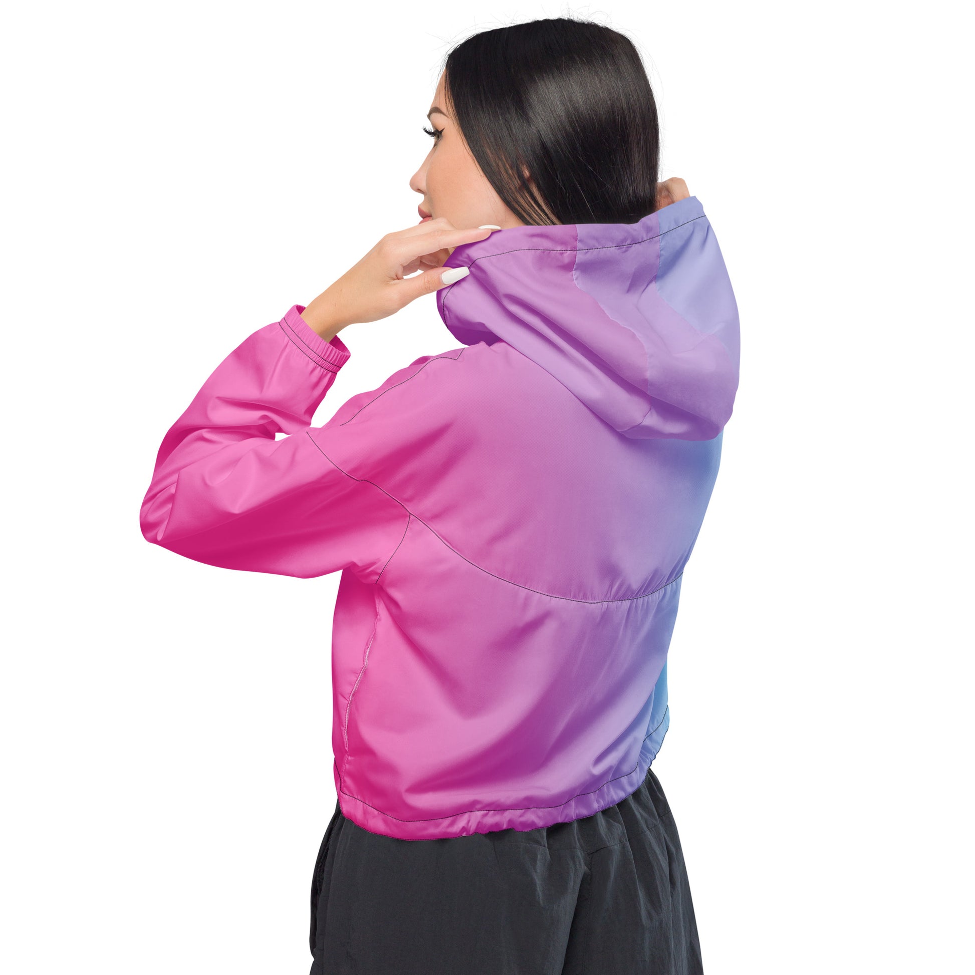 Woman wearing cropped jacket with color scheme that fades from pink, to purple, to light blue.