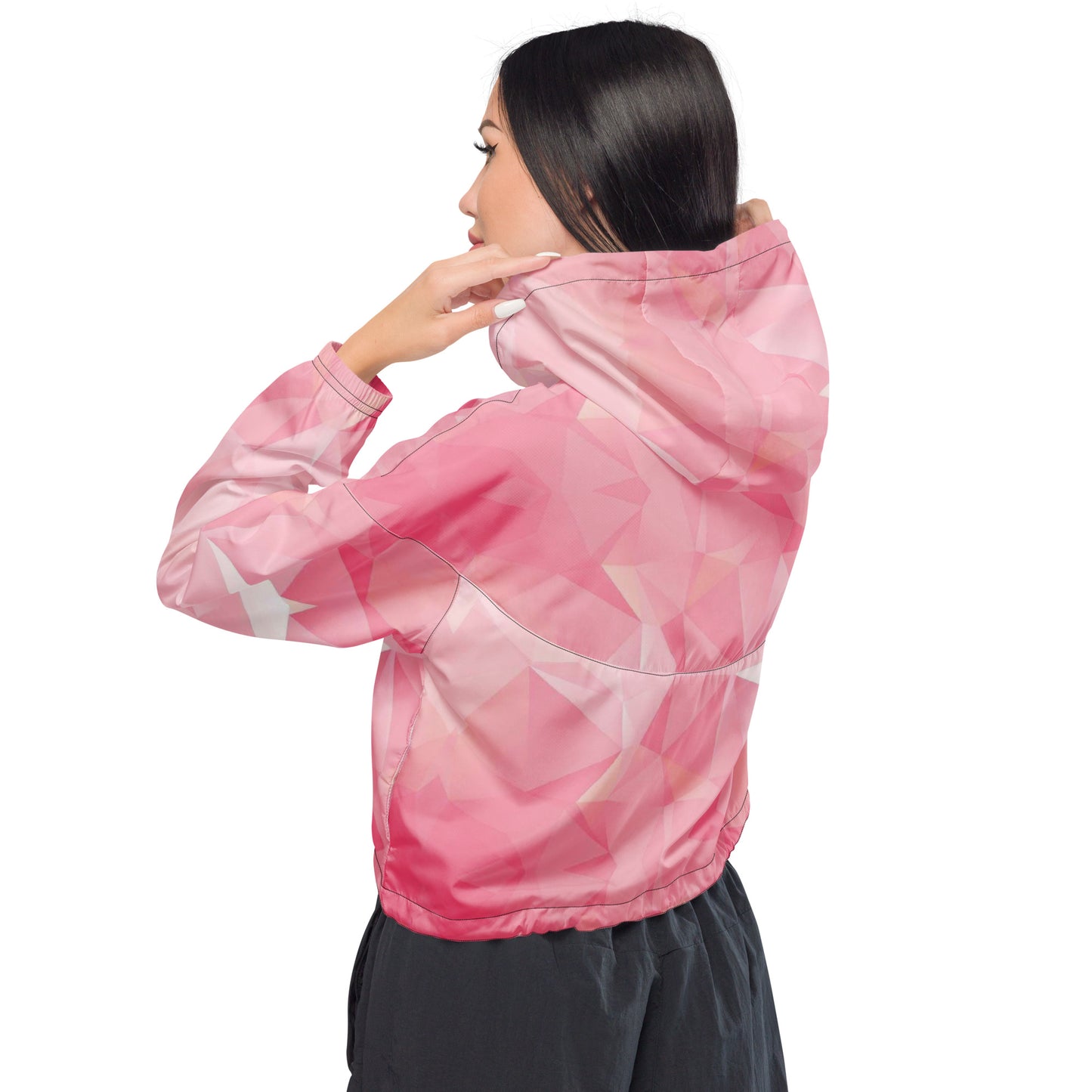 Woman wearing cropped jacket with pink geometric pattern.