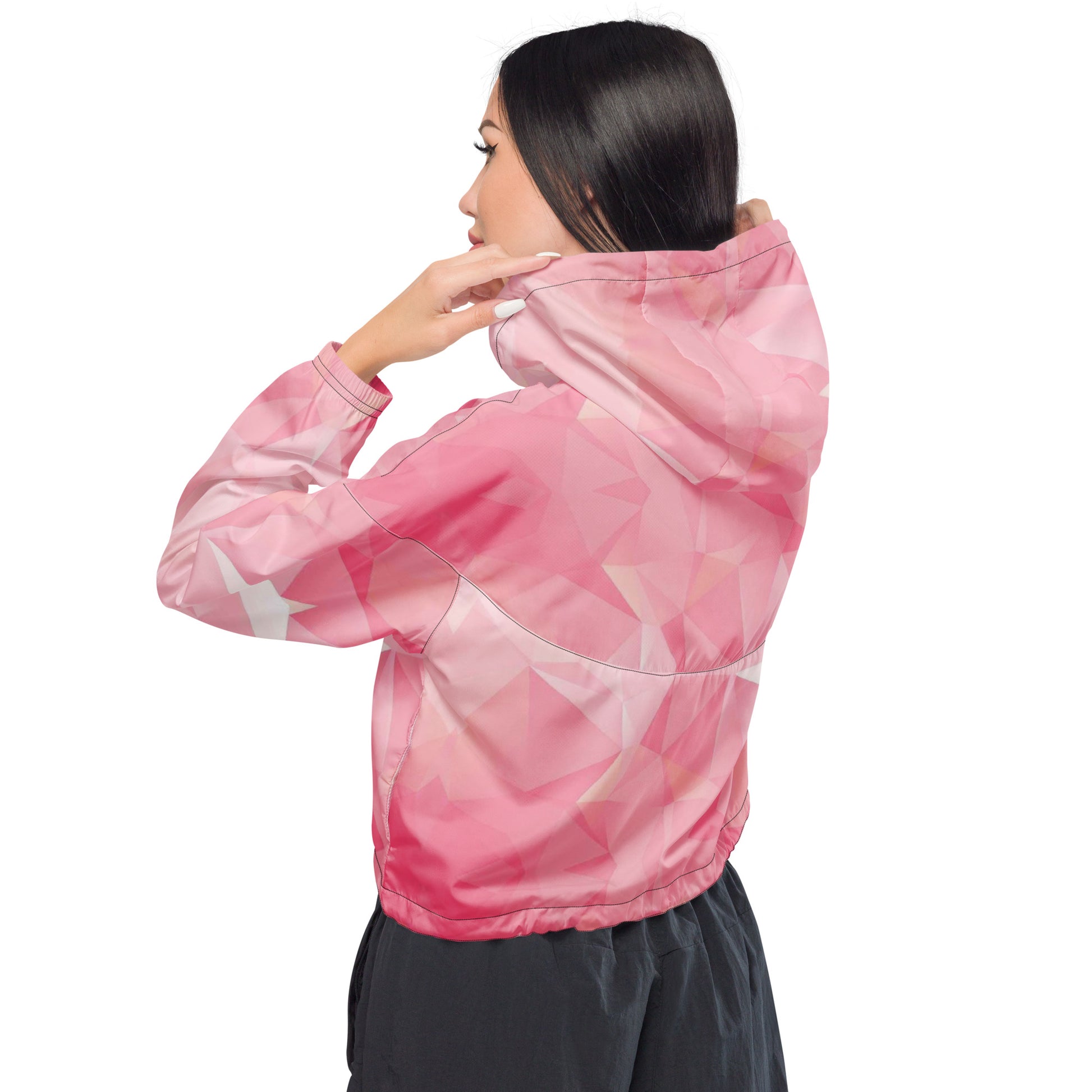 Woman wearing cropped jacket with pink geometric pattern.