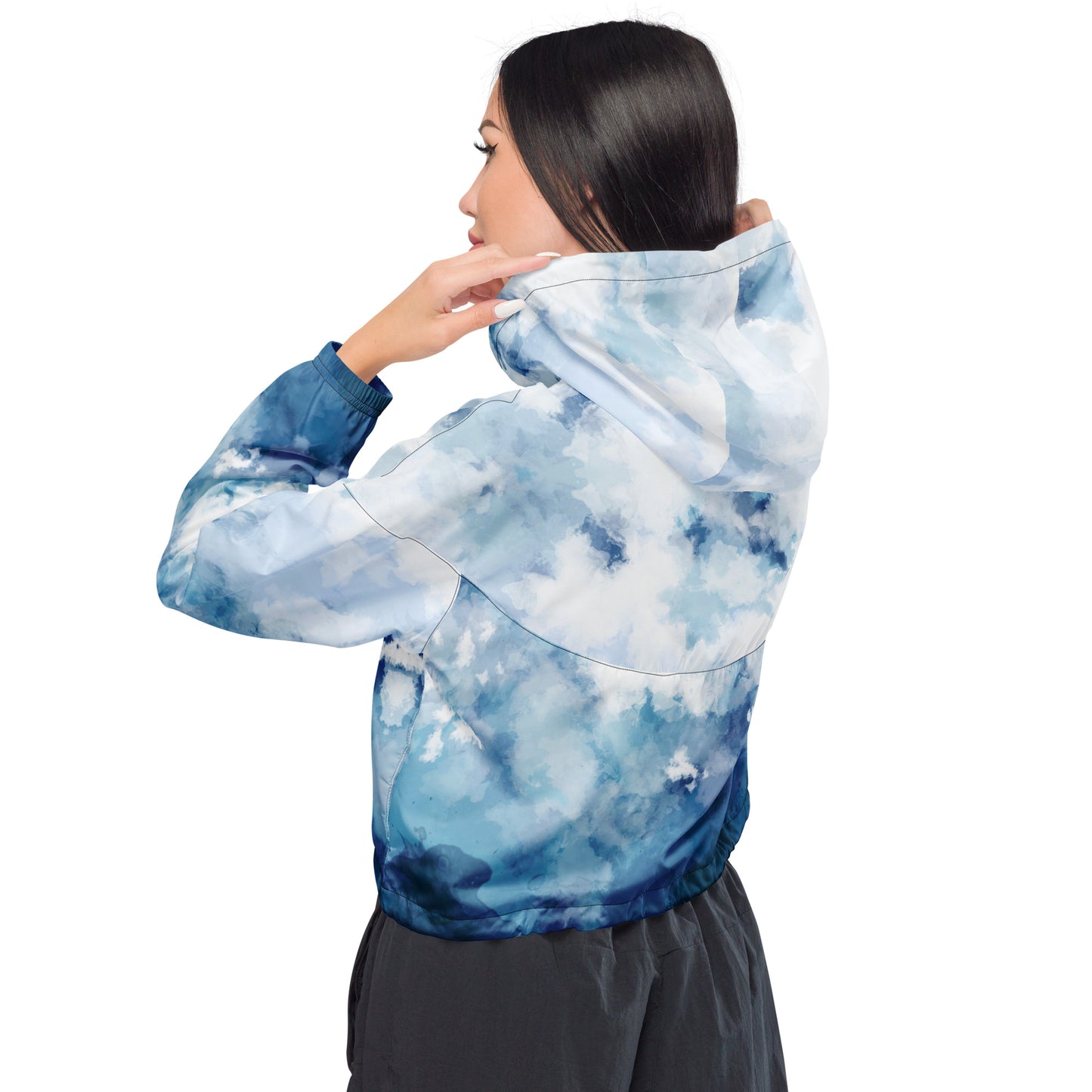Woman wearing cropped jacket with blue-white watercolor pattern.