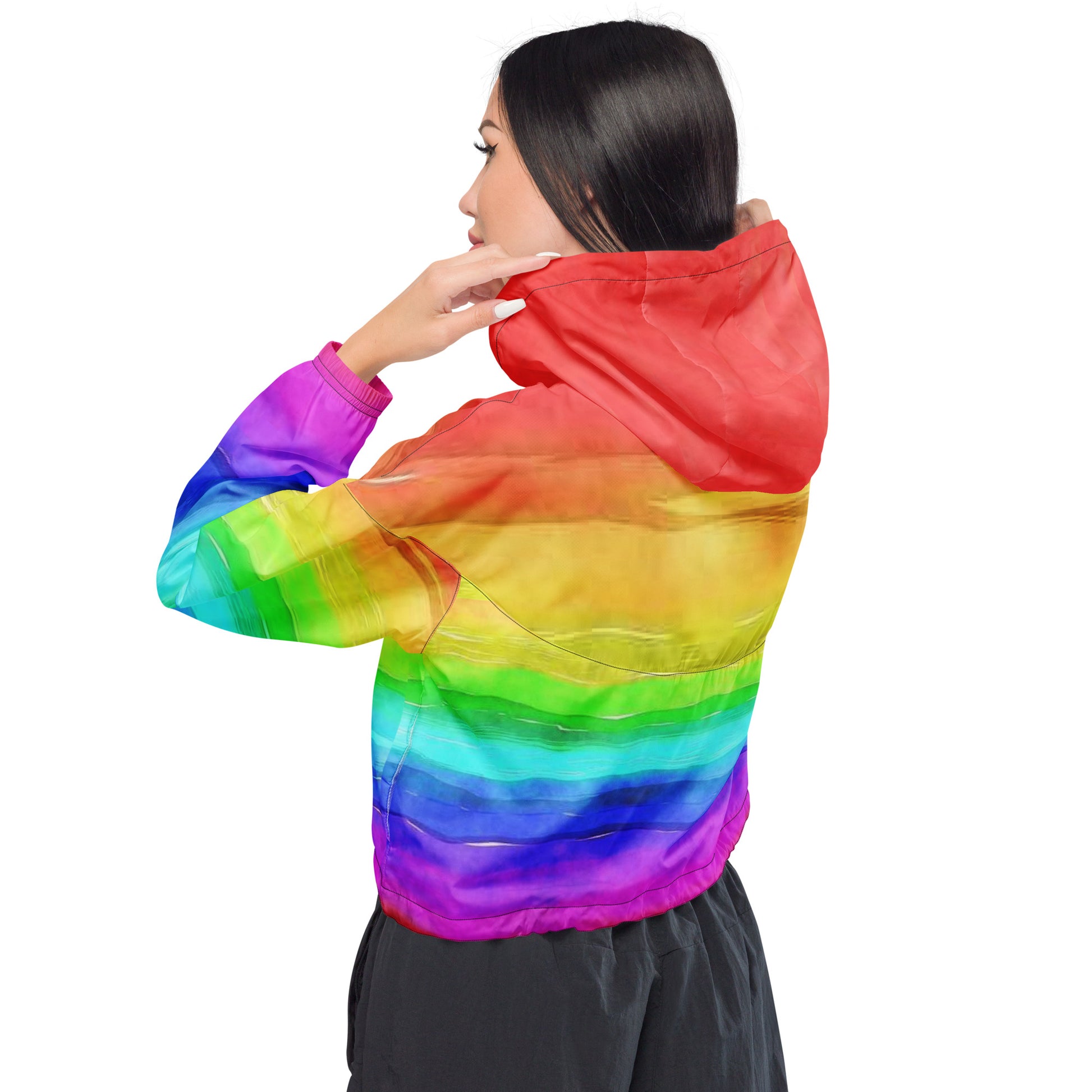 Woman wearing cropped jacket with rainbow pattern resembling watercolor.