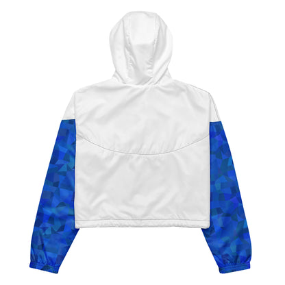 White back of cropped jacket. Sleeves have blue geometric pattern.