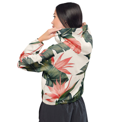 Woman wearing cropped windbreaker with tropical floral design.