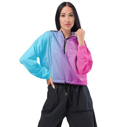Woman wearing cropped jacket with color scheme that fades from light blue, to purple, to pink.