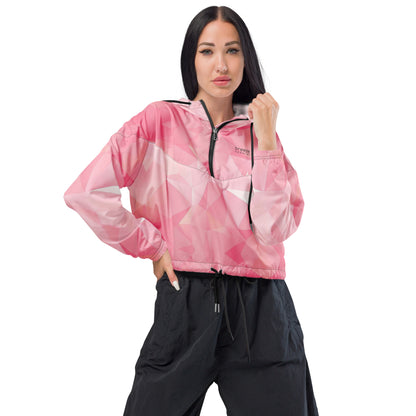 Woman wearing cropped jacket with pink geometric pattern.