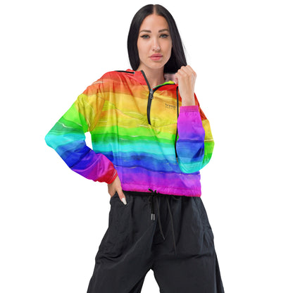 Woman wearing cropped jacket with rainbow pattern resembling watercolor.