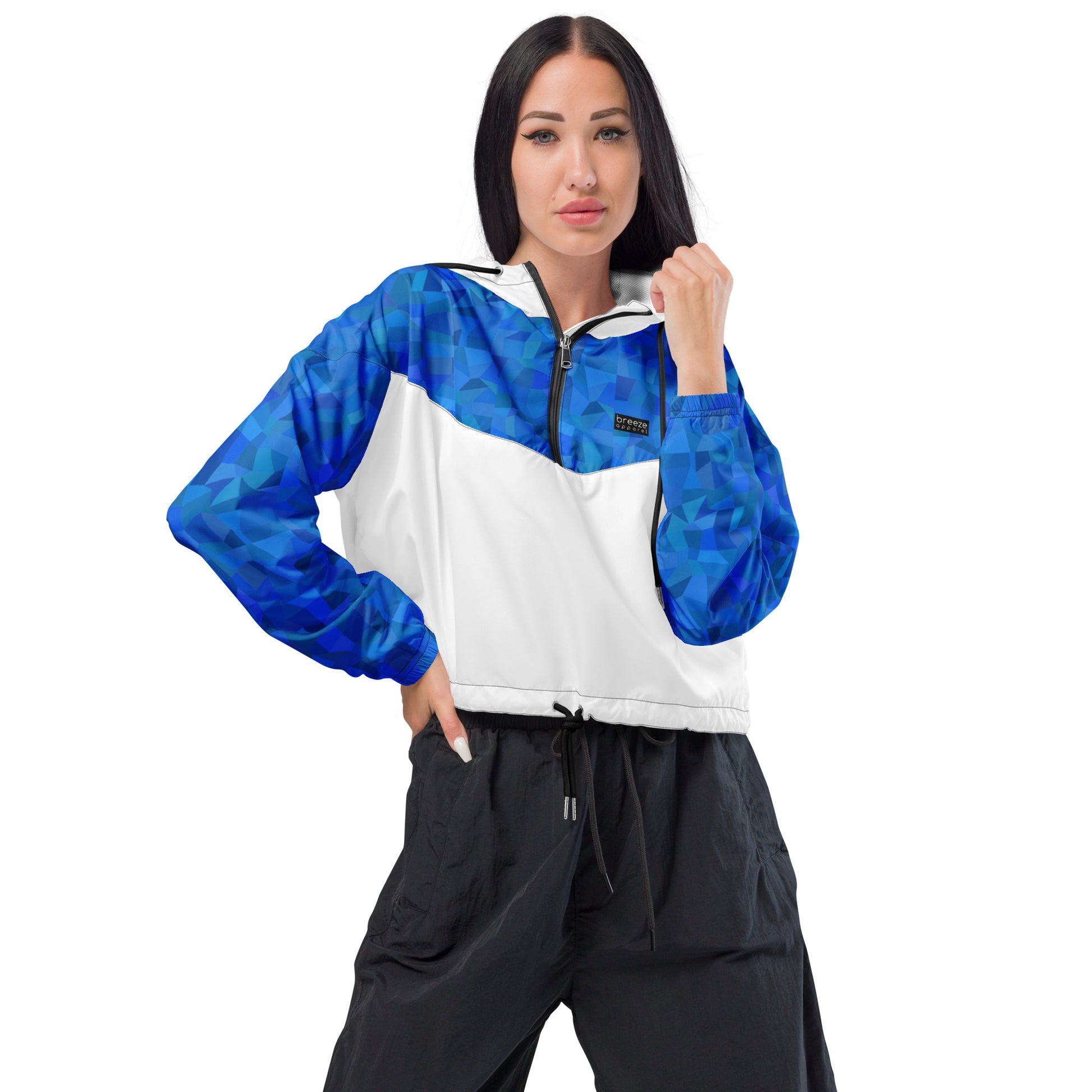 Woman wearing cropped jacket with blue geometric pattern on top and sleeves; rest is white.