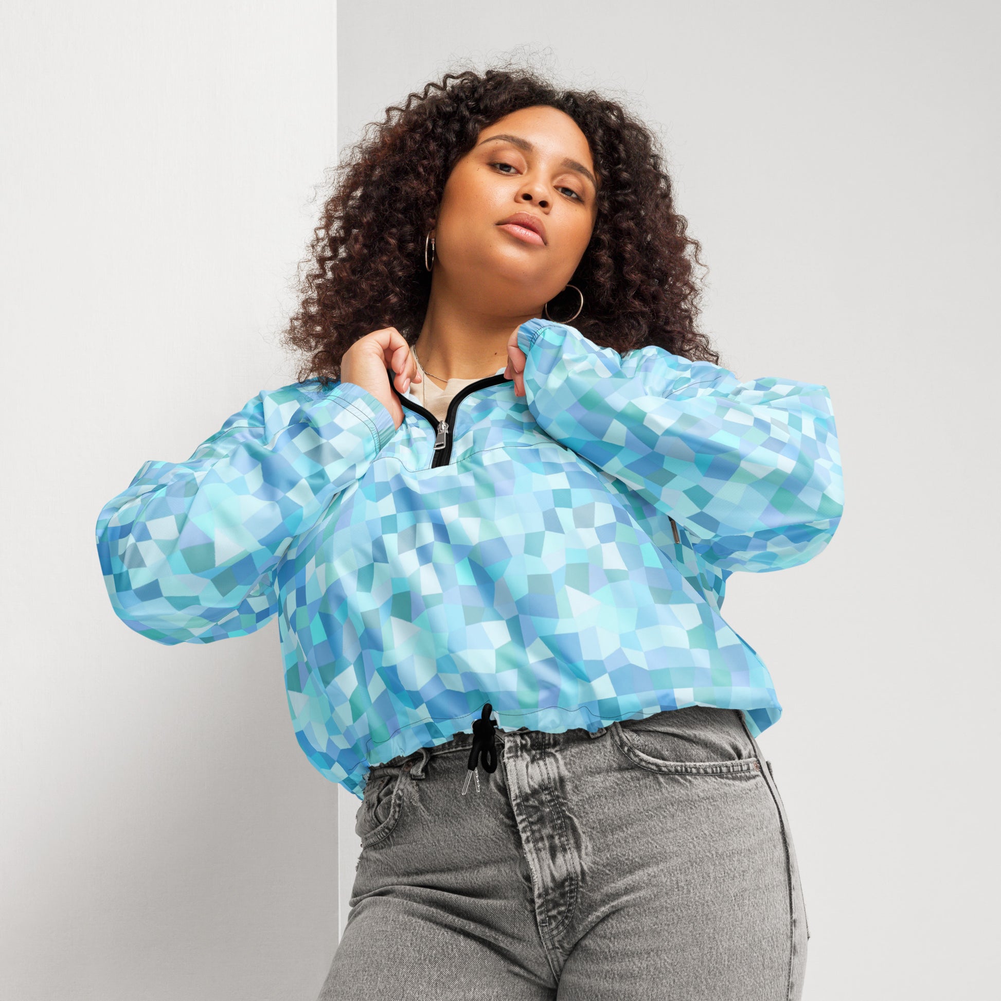 Woman wearing cropped jacket with light-blue geometric pattern.