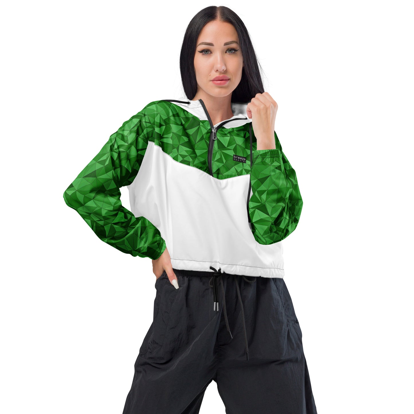 Woman wearing cropped windbreaker with green geometric pattern on top half and sleeves; rest is white.