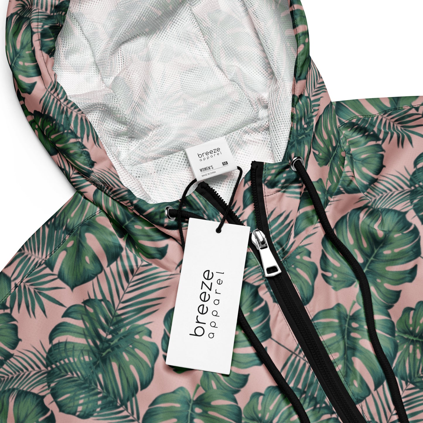 Jacket with pattern of green palm leaves set on a pink background.