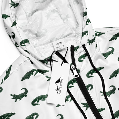 White, cropped windbreaker with pattern of green alligators.