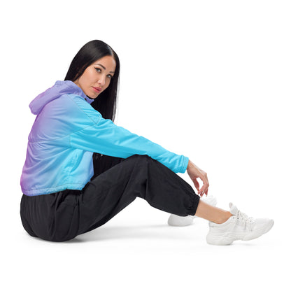Woman wearing cropped jacket with color scheme that fades from light blue, to purple, to pink.