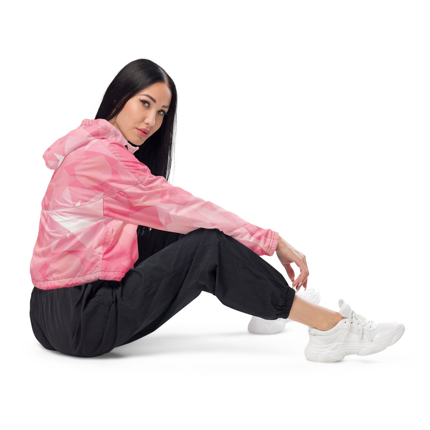Woman wearing cropped jacket with pink geometric pattern.