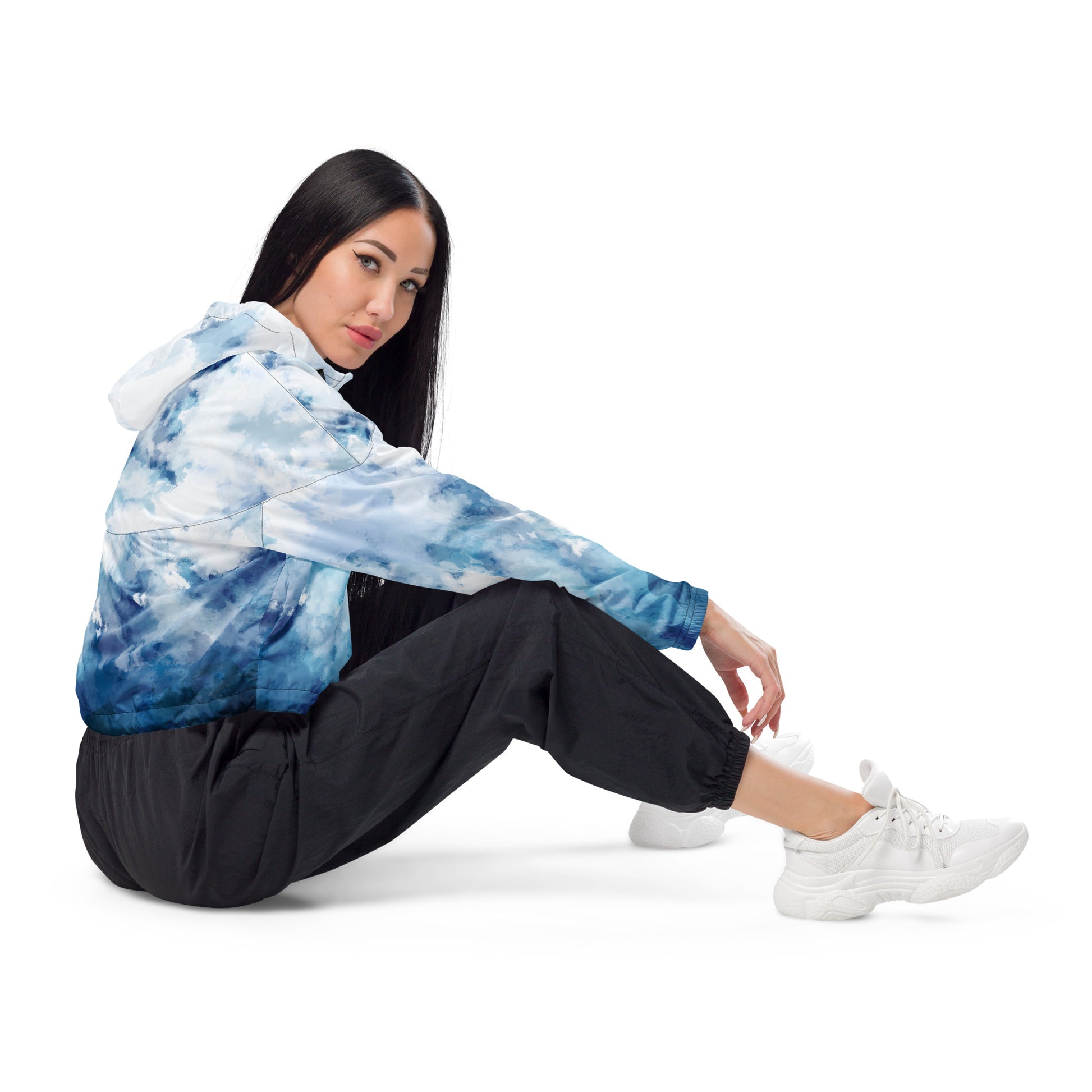 Woman wearing cropped jacket with blue-white watercolor pattern.