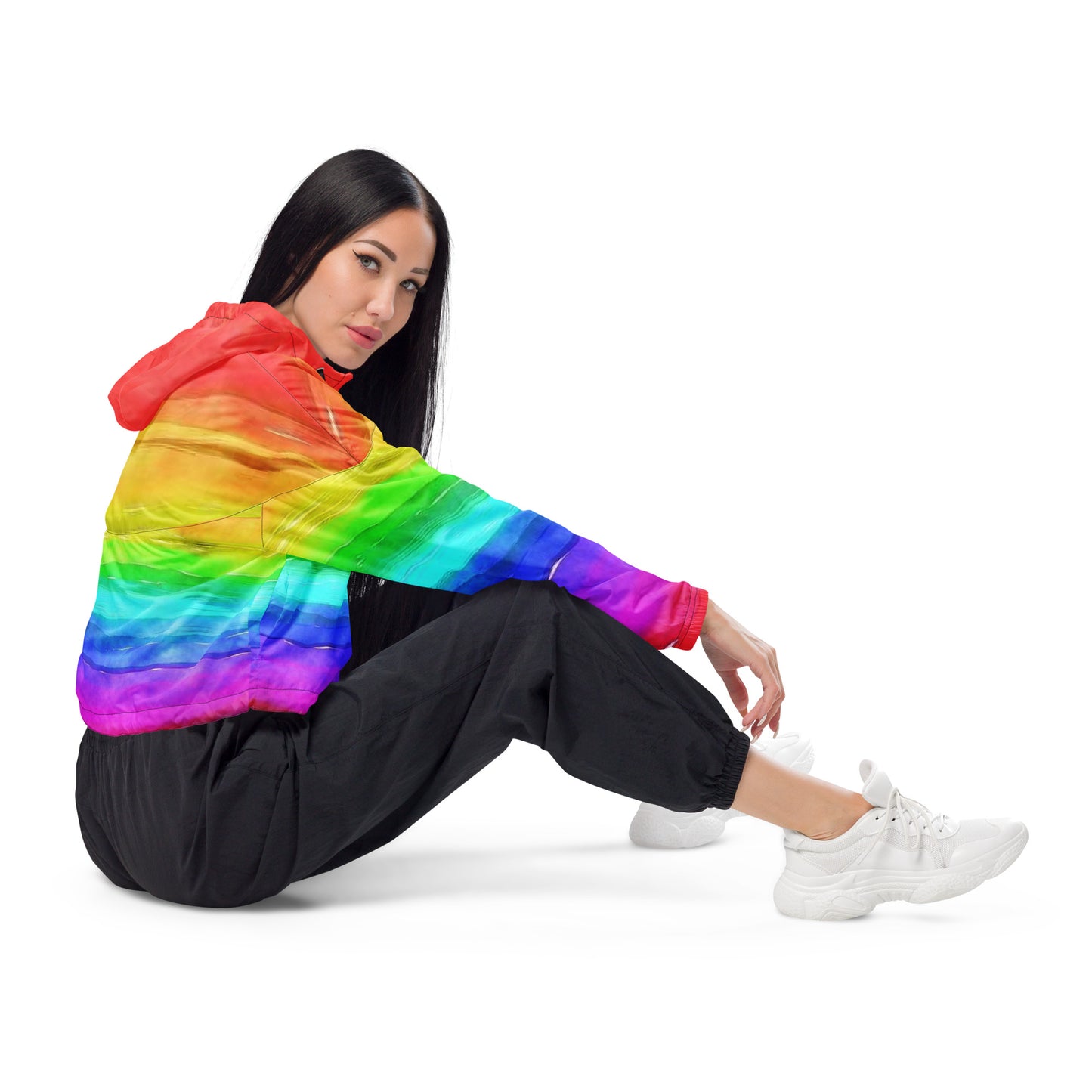 Woman wearing cropped jacket with rainbow pattern resembling watercolor.