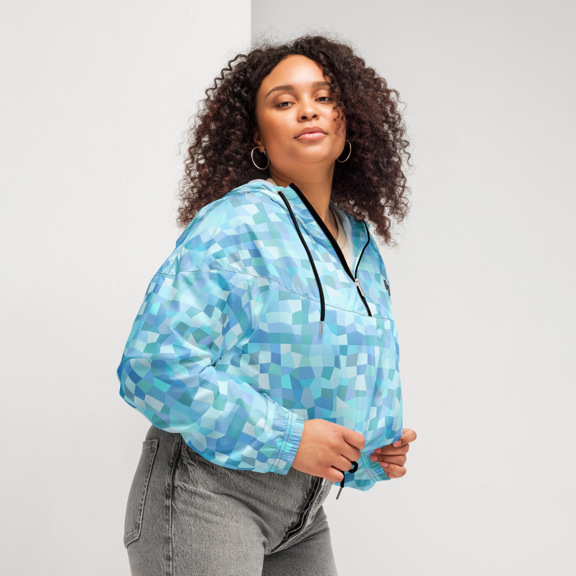 Woman wearing cropped jacket with light-blue geometric pattern.