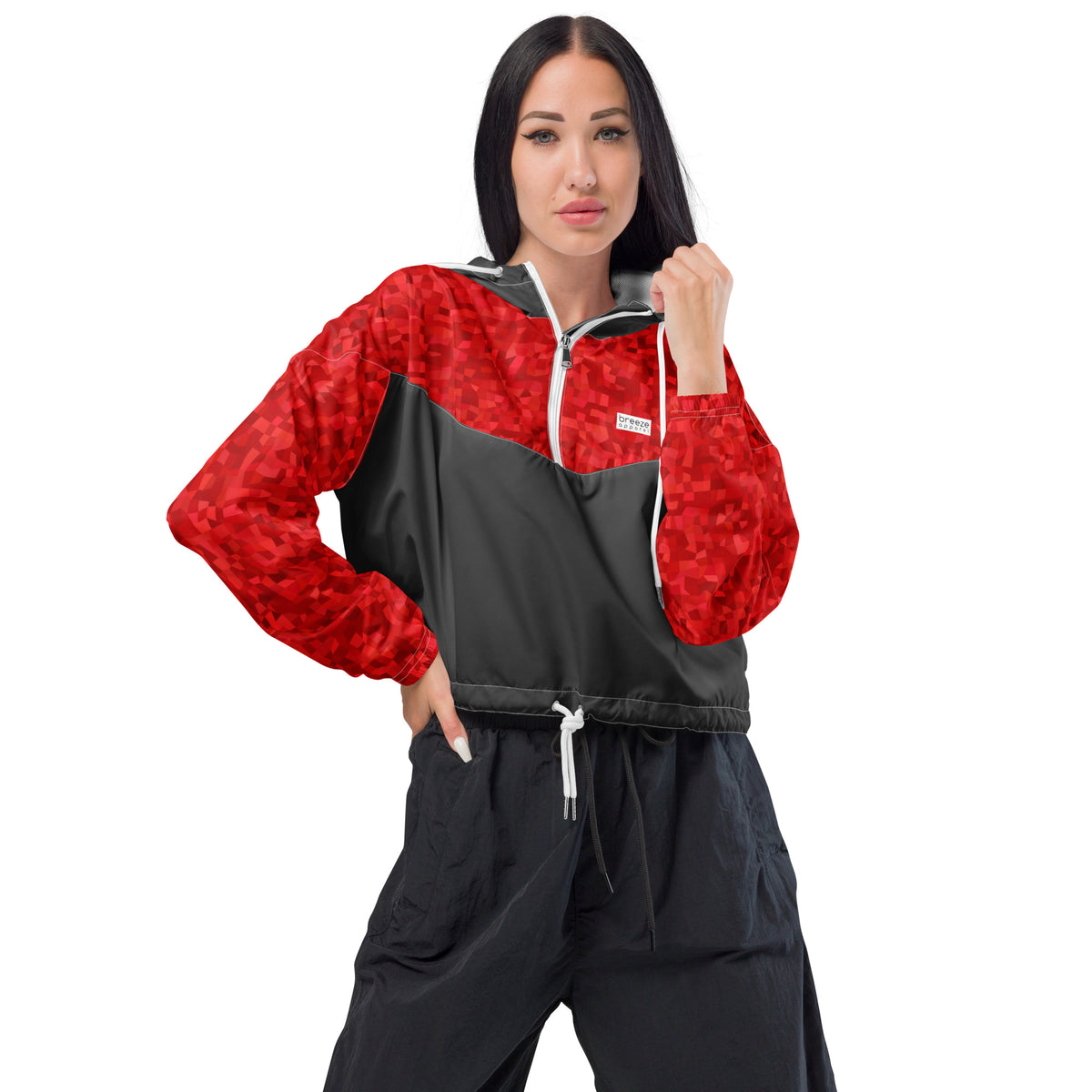 Woman wearing cropped jacket with red geometric pattern on top and sleeves; rest is gray.