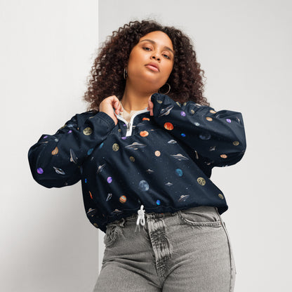 Woman wearing cropped windbreaker with pattern of UFOs and planets in space.