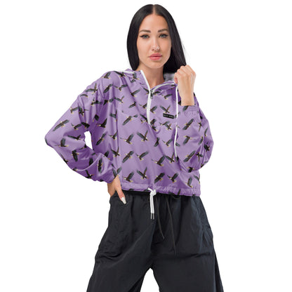 Woman wearing cropped, purple windbreaker with pattern of bald eagles.