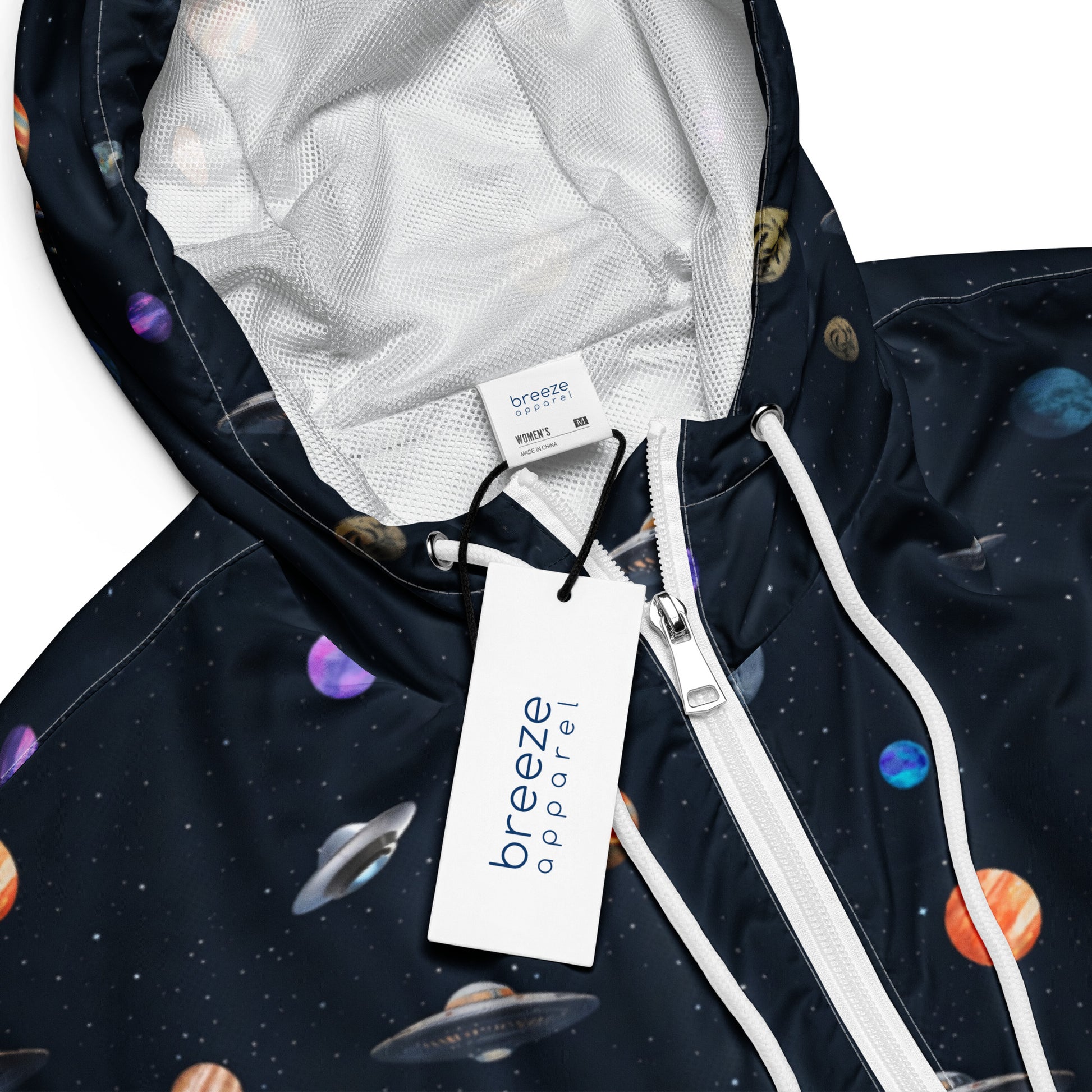 Windbreaker with pattern of UFOs and planets in space.