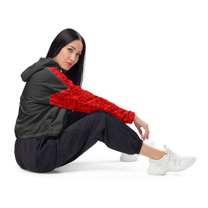 Woman wearing cropped jacket with red geometric pattern on top and sleeves; rest is gray.