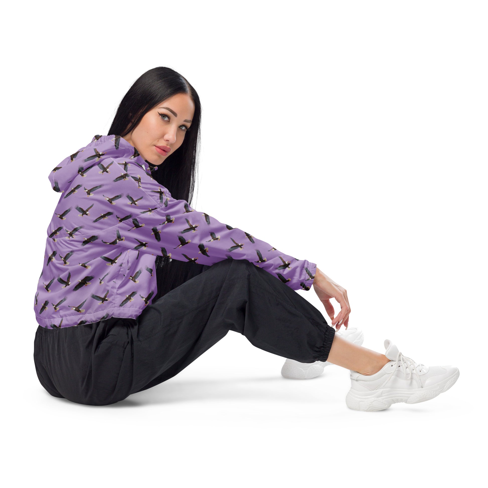 Woman wearing cropped, purple windbreaker with pattern of bald eagles.