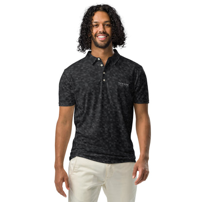 Man wearing polo shirt with dark-gray geometric pattern.
