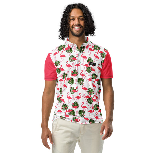 Man wearing polo with pattern of pink flamingos and green palm leaves set on a white background. Sleeves are pink.